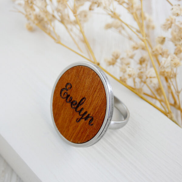 Adjustable engraved ring made with natural wood and stainless steel.