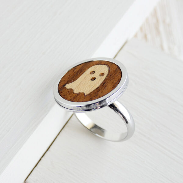 Adjustable handmade ghost ring with walnut base and stainless steel