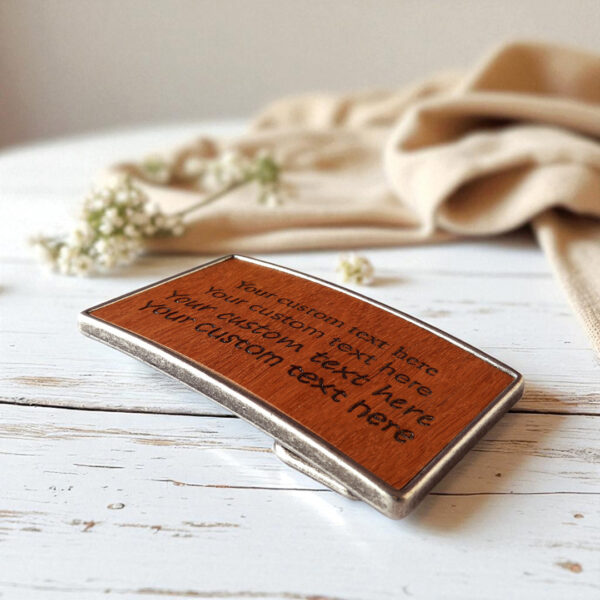 Wooden belt buckle engraved with a custom phrase or name.