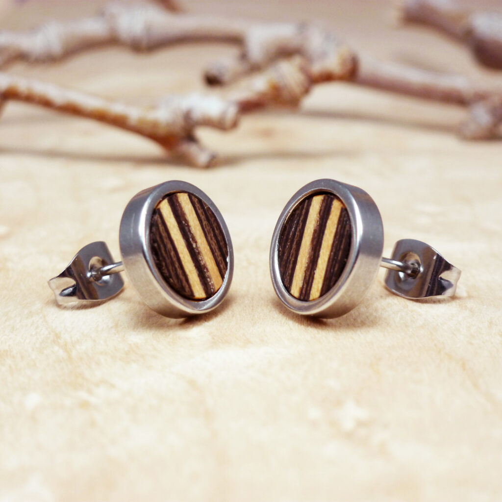 Small post earrings made with dark wenge wood and light sycamore stripes