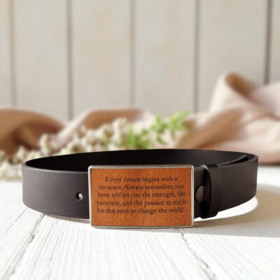 Engraved wooden belt buckle with black leather strap for a personalized and stylish accessory.