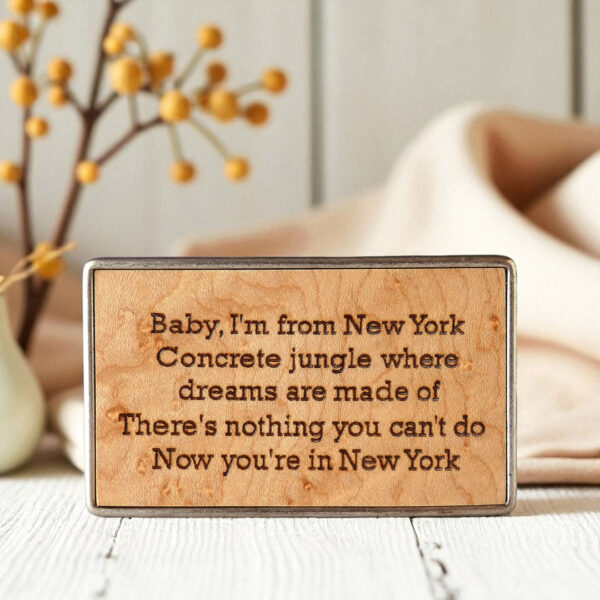 Engraved wooden belt buckle with detailed custom text.