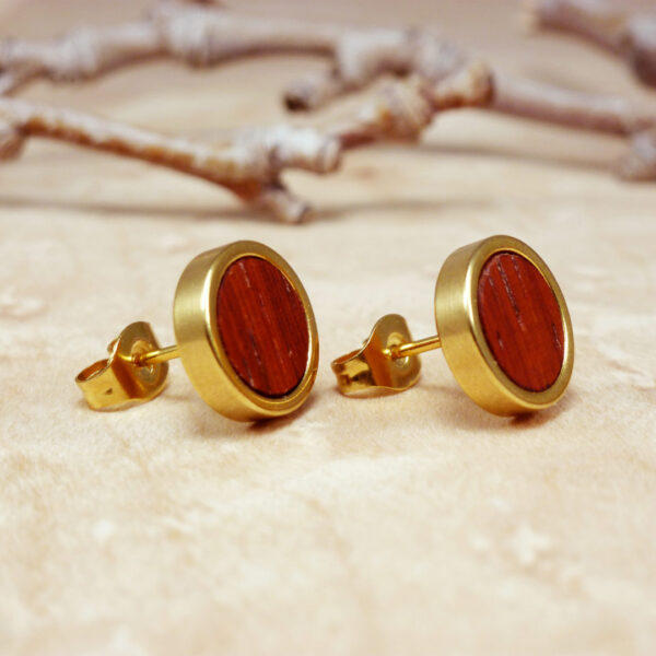 Close-up of gold plated stud earrings with padauk wood – handmade colorful wood jewelry
