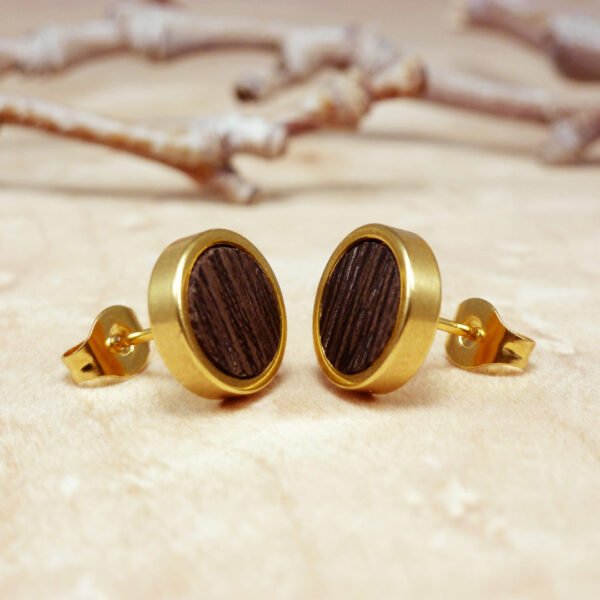 Close-up of gold plated stud earrings with dark wenge wood – handmade natural design