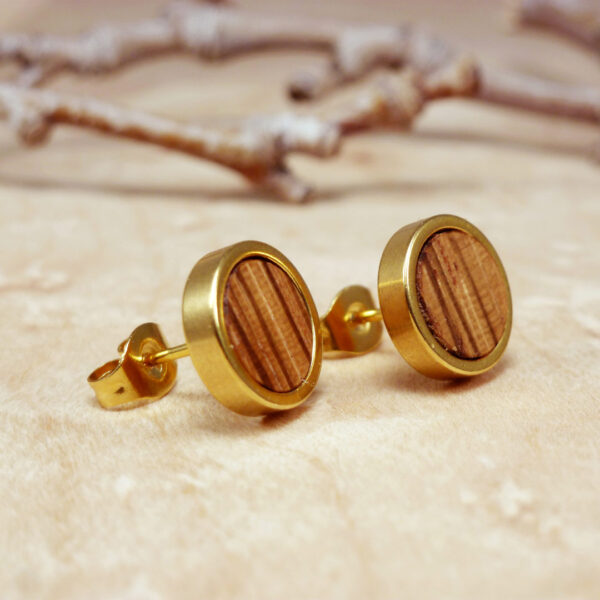 Close-up of gold plated stud earrings with zebrano wood – striped handmade earrings