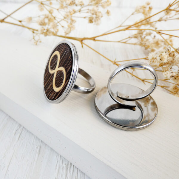 Adjustable wooden infinity rings with stainless steel and gold finishes