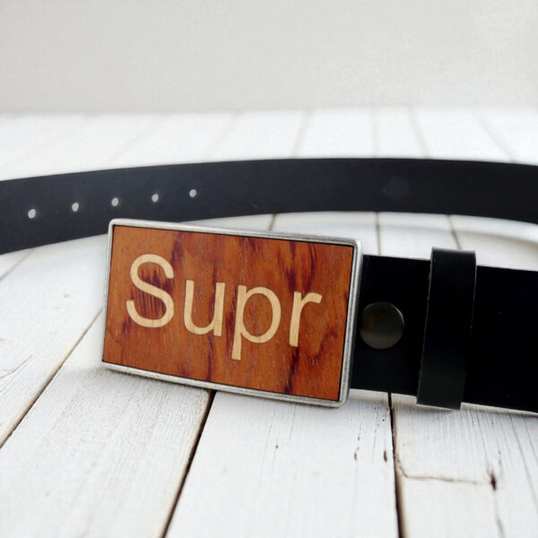 Interchangeable wood and metal belt buckle with Supr key design