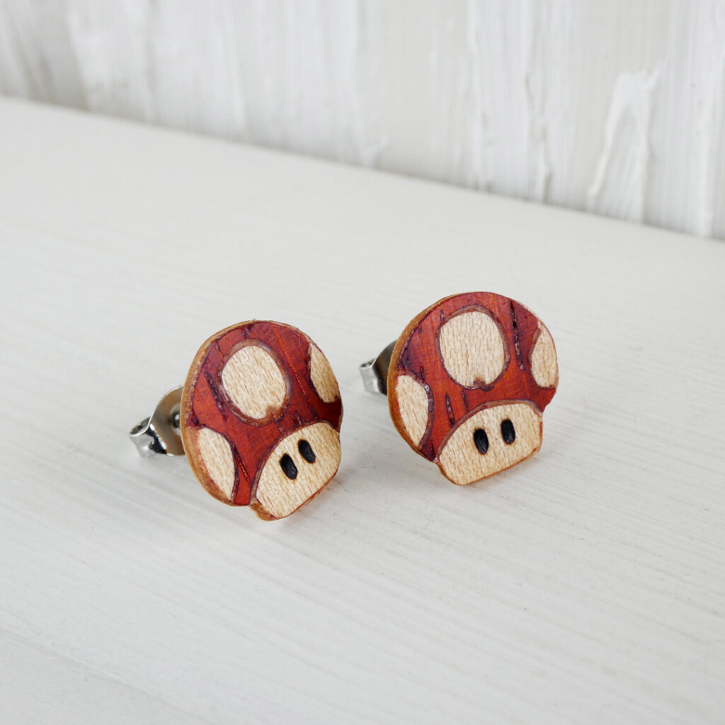 Handmade Mario mushroom earrings crafted using coral and sycamore wood marquetry