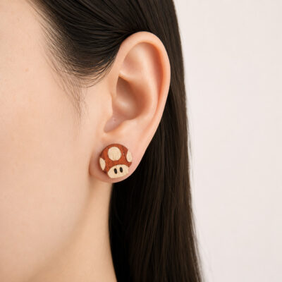 Wooden Mario mushroom earrings worn on the ear