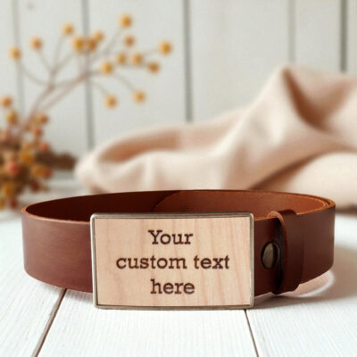 Personalized wooden belt buckle handcrafted with engraved text and natural wood.