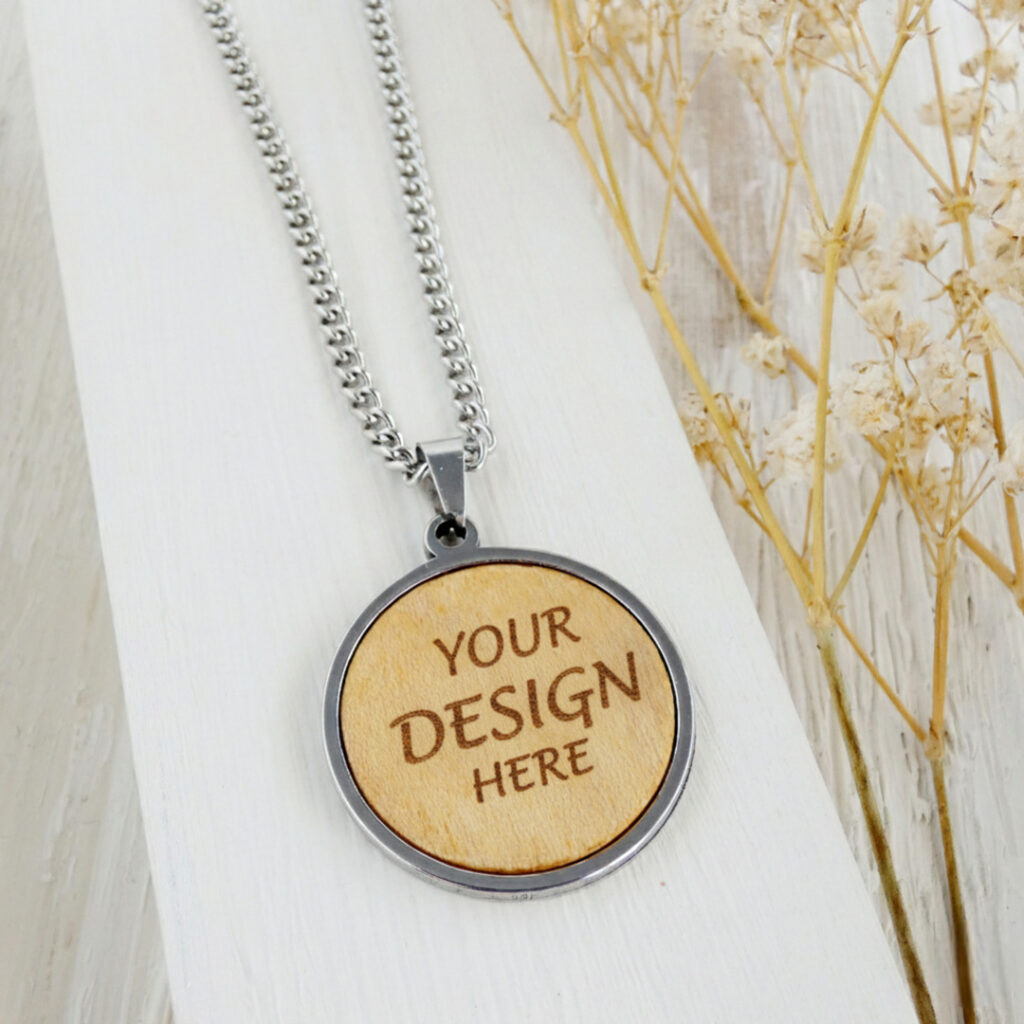 Personalized wooden necklace engraved with the words Your Design Here in a stainless steel pendant