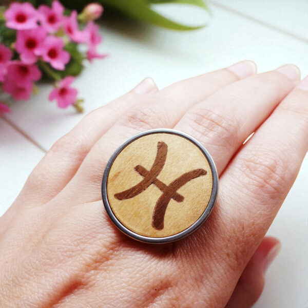 Wooden Pisces zodiac ring with natural light