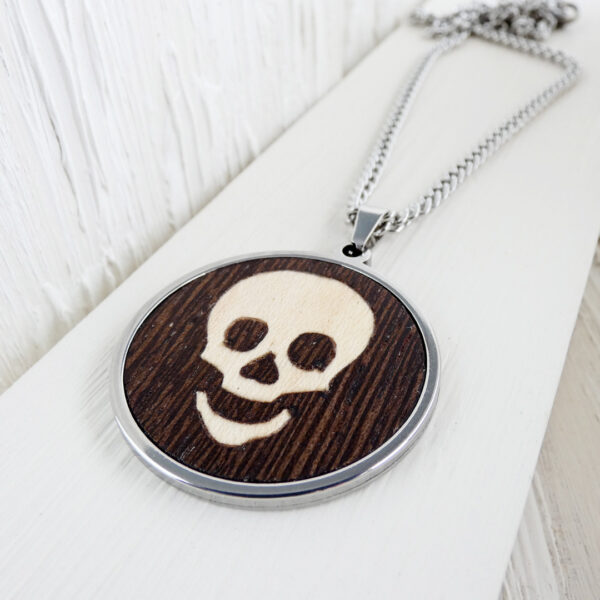 Stainless steel and wood skull necklace worn by a man
