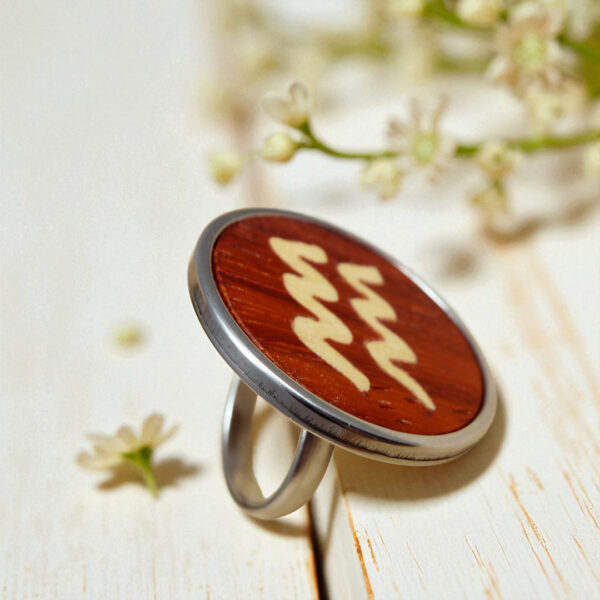 Stainless steel ring with Aquarius zodiac symbol in natural wood