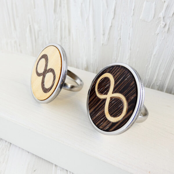 Pair of stainless steel infinity rings with wenge and sycamore wood