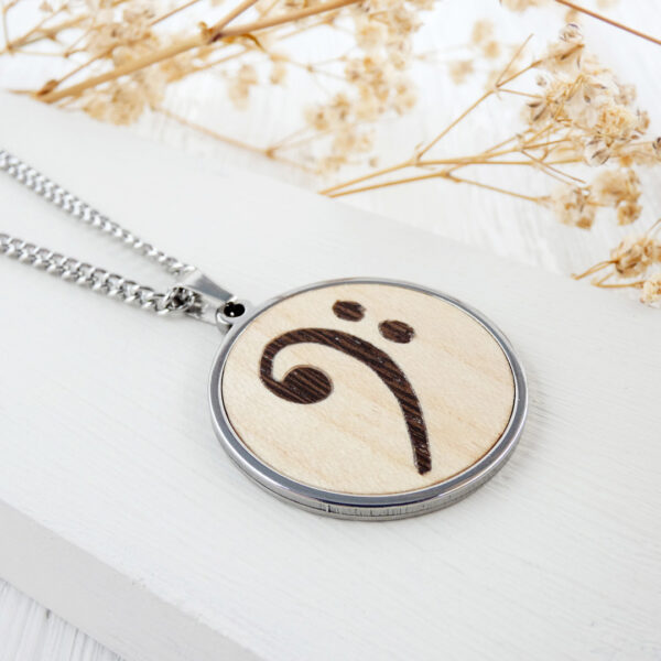 Stainless steel necklace with natural wood bass clef symbol