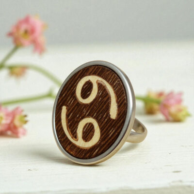 Adjustable wooden cancer ring with marquetry zodiac symbol and stainless steel base