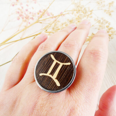 Woman wearing a wooden Gemini ring on hand