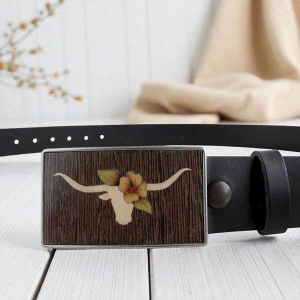 Wooden marquetry of longhorn skull and flower on belt buckle