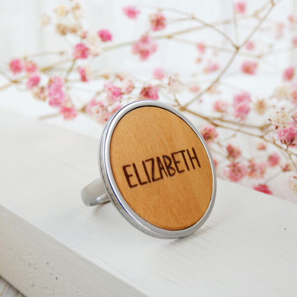 Custom wooden ring gift for sisters with name engraving and steel base.