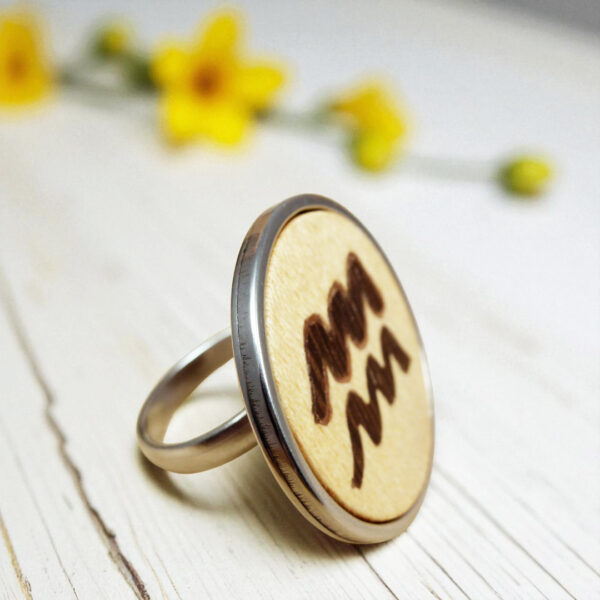 Wood and steel ring with Aquarius zodiac sign in marquetry
